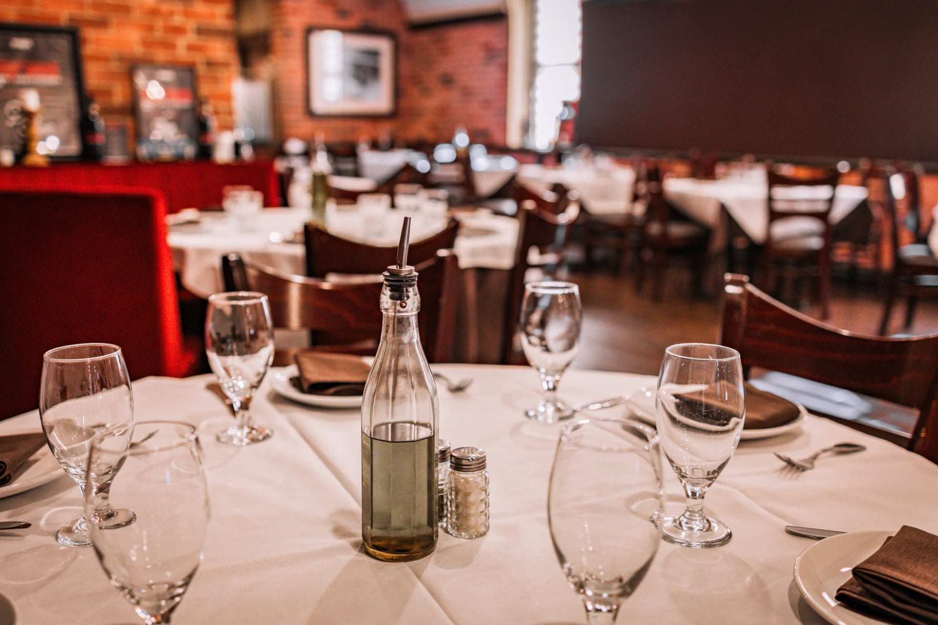 Place setting with wine glasses and silverware on a white tablecloth at Da Nico Ristorante