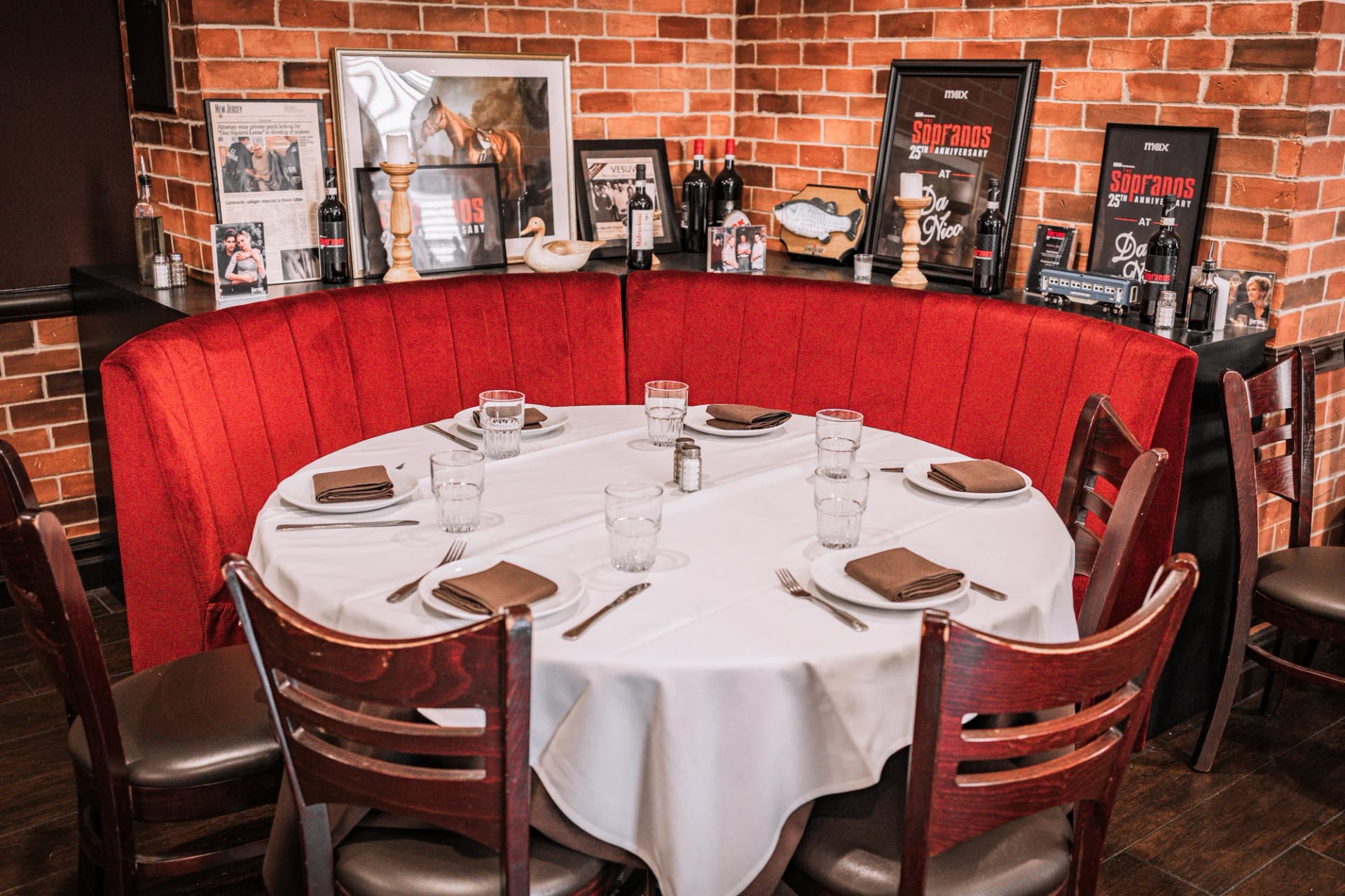 Corner of the Da Nico Ristorante dining room with white tablecloths, mirrors, and a ceiling fan