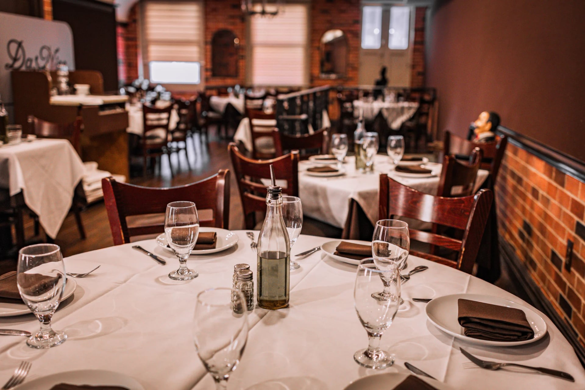 Square dining table set for four with wine glasses at Da Nico Ristorante on Mulberry Street