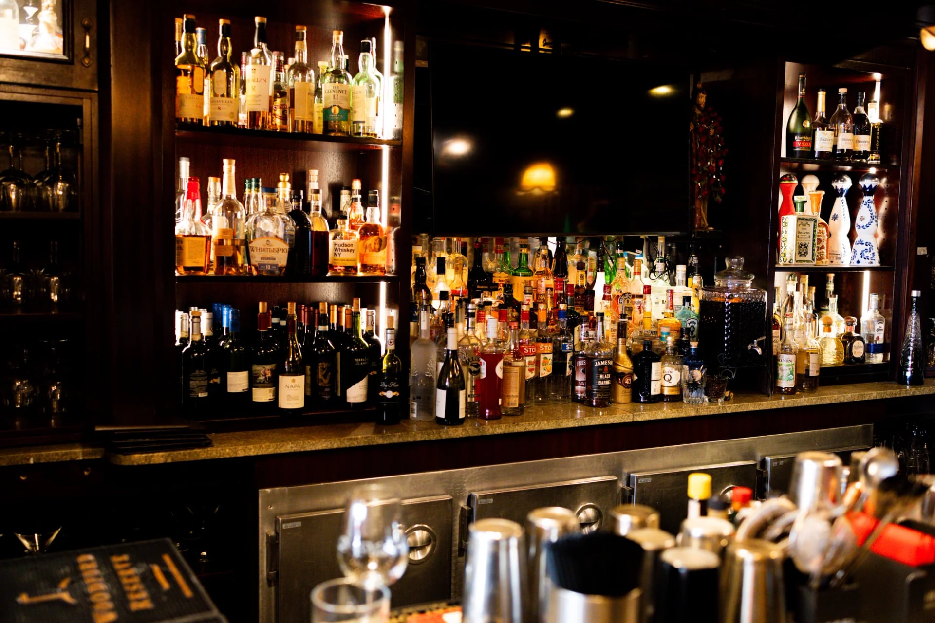 Marble bar with a backlit bottle display at Da Nico Ristorante on Mulberry Street, Little Italy