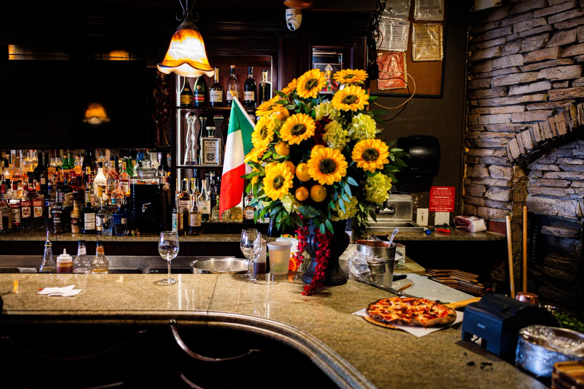 Backlit liquor shelves behind the bar at Da Nico Ristorante in Little Italy