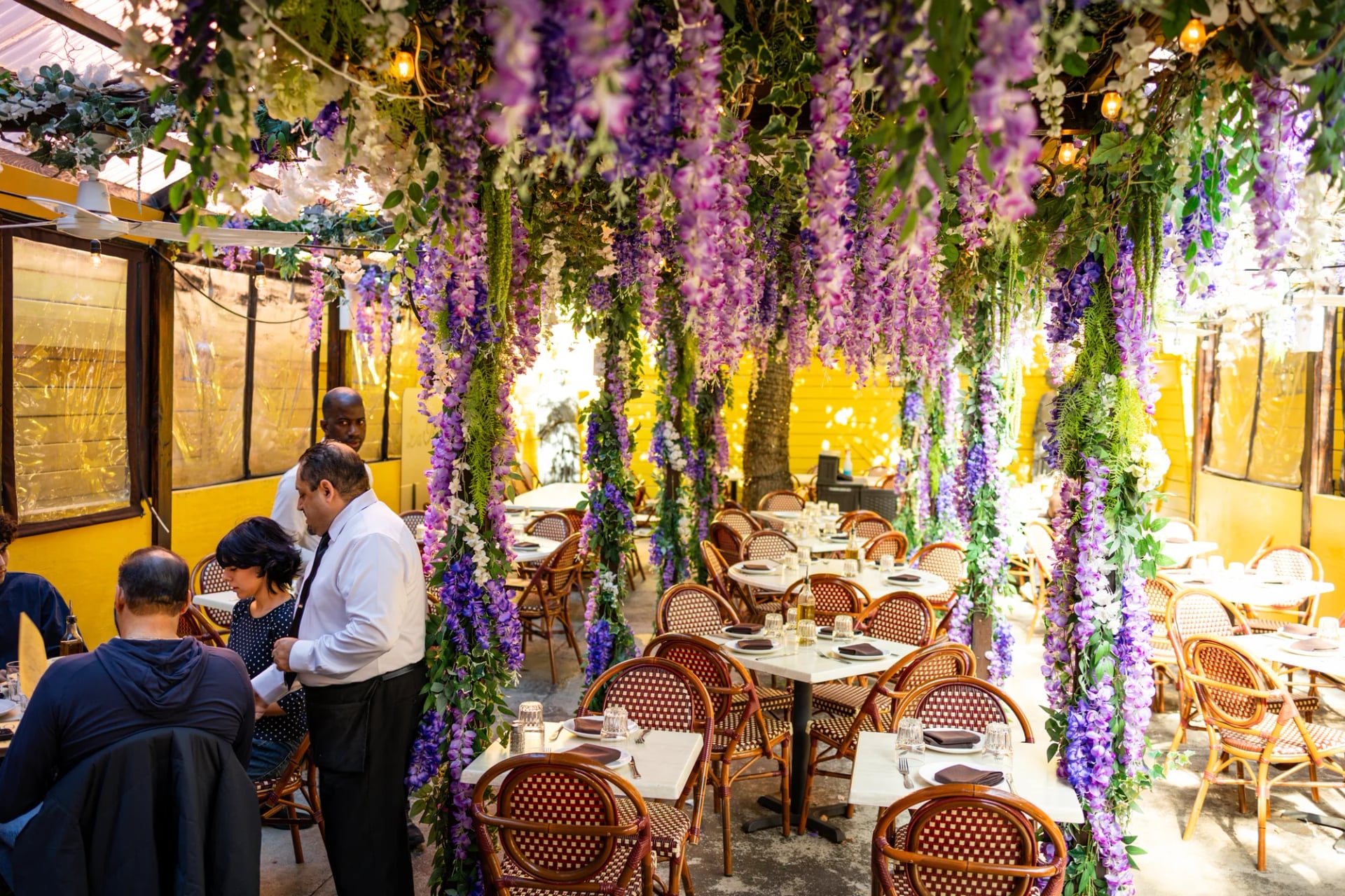 Evening view of the Da Nico garden patio with string lights and umbrella tables