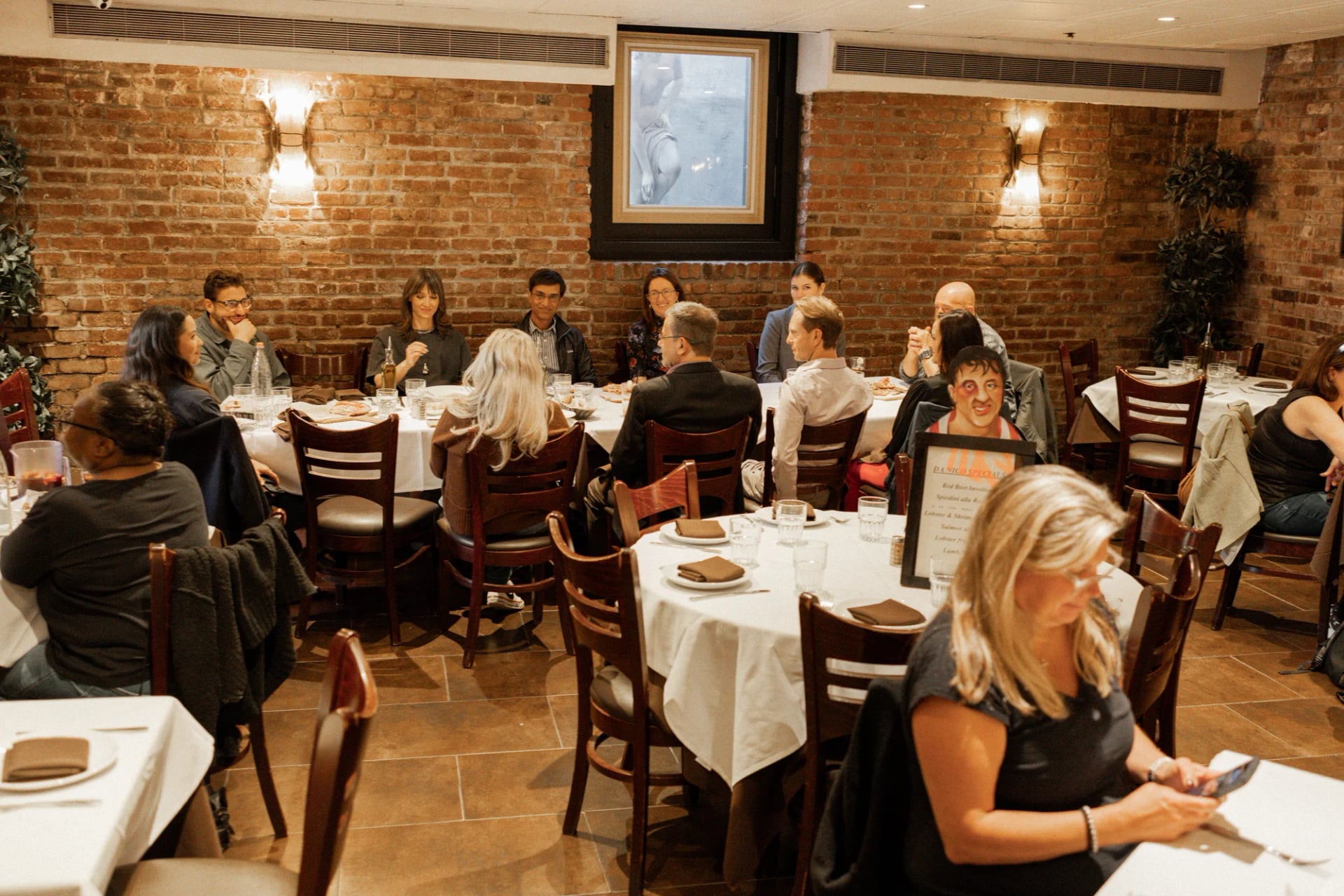 Guests gathered at a large round table in the Da Nico Ristorante dining room